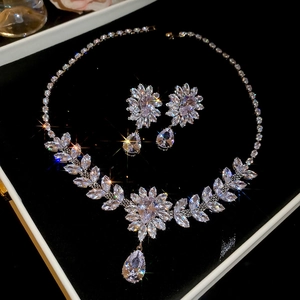Sparkling zircon leaf and floral jewelry set with teardrop pendant on black velvet