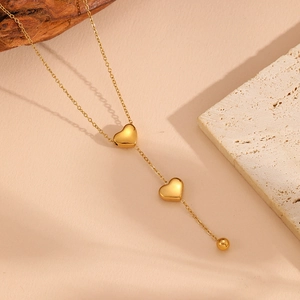 Elegant gold stainless steel Y-necklace with double heart pendants and bead tassels