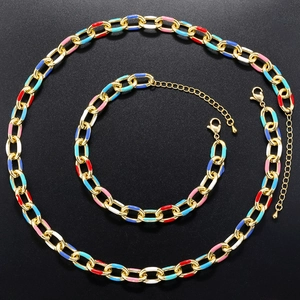 Detail of gold-plated jewelry set with colorful enamel links and lobster clasp closures