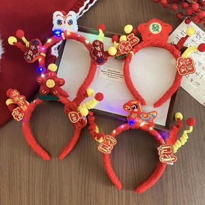 Detailed close-up of festive red New Year headbands with LED lights and lion dance motifs