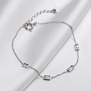 Detail of titanium steel necklace featuring rectangular zircons and a heart pendant