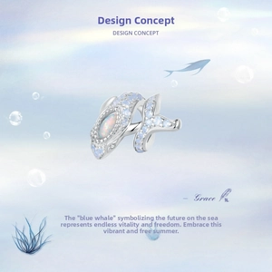 Detail of whale charm in S925 silver with blue stones and iridescent opal center