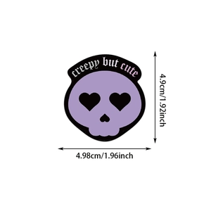 Macro detail of creepy but cute purple heart-eye skull sticker measuring 4.9cm