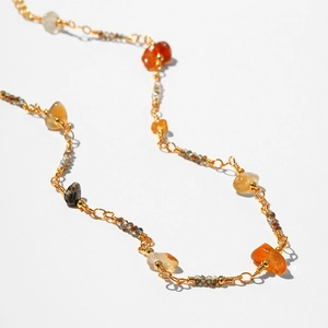 Bohemian gold chain necklace with colorful irregular natural stones and wire-wrapped detail