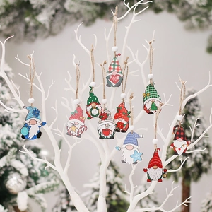 Colorful wooden Christmas gnome ornaments hanging on white branches for holiday home decor
