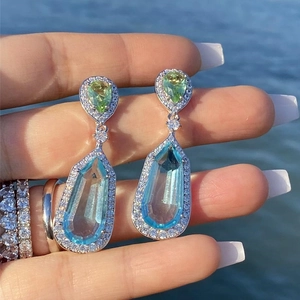 Bohemian silver drop earrings with light blue gemstone and green pear-shaped accents