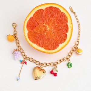 Detailed view of 18K gold stainless steel bracelet with colorful fruit and heart charms