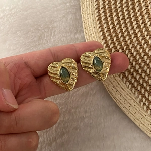 Vintage heart-shaped gold studs with wrinkled texture and green oval gemstone inserts