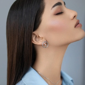 Polished 925 sterling silver hoop stud earrings with tiny zircon stone on model ear