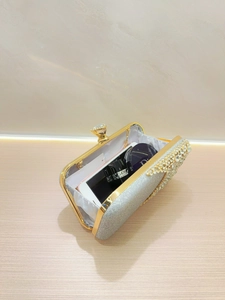 Detailed interior of rhinestone evening bag showing space for phone and makeup