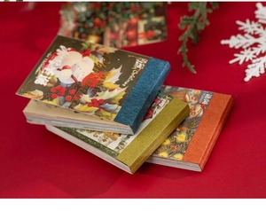 Close-up of vintage Christmas gold-stamped washi stickers with retro holiday illustrations