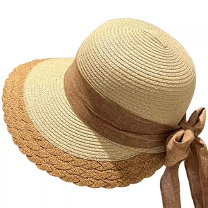 Women's minimalist straw sun hat with wide wavy brim and brown ribbon bow decoration