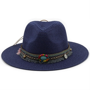 Detail of navy straw fedora hat featuring bohemian beaded band with turquoise and tassel