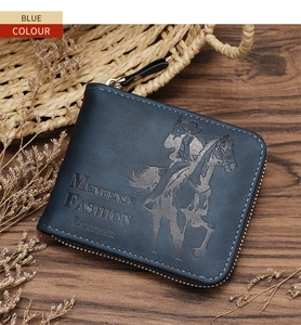 Close-up of vintage blue leather wallet with embossed horse rider pattern on wood table