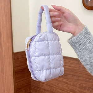 Lavender quilted square cosmetic bag with a single handle and golden zipper closure