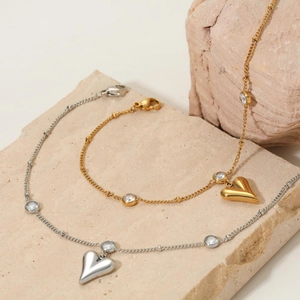 Elegant gold and silver stainless steel heart anklets with zircon charms on a stone