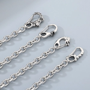 Detail of silver punk wallet chains featuring wolf and skull head hooks in polished steel