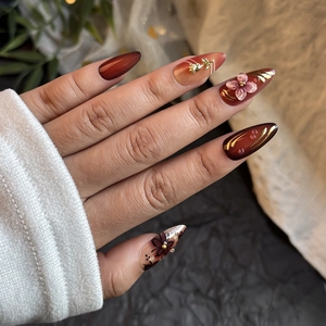 Brown almond press-on nails with red gradient, 3D floral accents and gold foil details