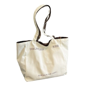 Minimalist canvas tote bag in off-white with dark plaid pattern and printed text