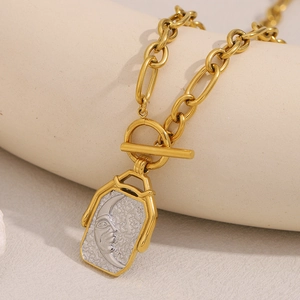 Detail of 18K gold-plated necklace with moon face square pendant and T-bar clasp