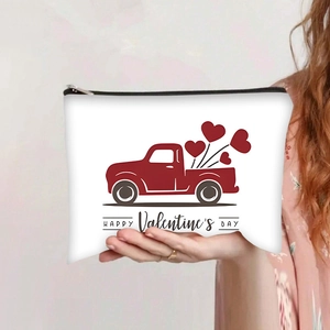 Detail of hand-held canvas makeup bag featuring red Valentine truck and heart balloons