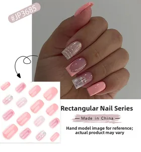 Detail of pink gradient long square press-on nails with silver stars and French lines