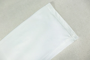 Close-up of double-needle stitching on white plain weave fabric sleeve hem of the suit