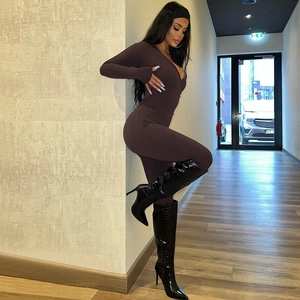 Close-up of coffee brown ribbed fabric texture on a slim fit long sleeve jumpsuit