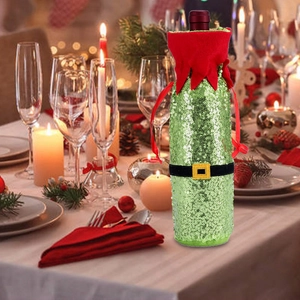 Close-up of green sequin Christmas wine bottle cover on a festive holiday table