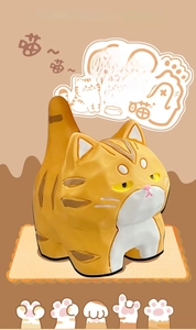 Detail of orange tabby cat resin figurine with wood carving texture and pink paw base