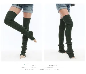 Detailed knit texture of dark green over-knee leg warmers with elastic ribbed design