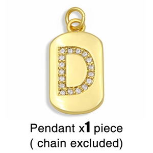 Macro shot of gold D-letter rectangular pendant with zircon inlays and glossy finish