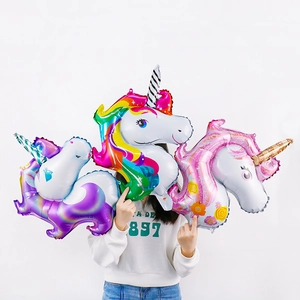 Three large standing 3D unicorn foil balloons in rainbow pink and purple colors