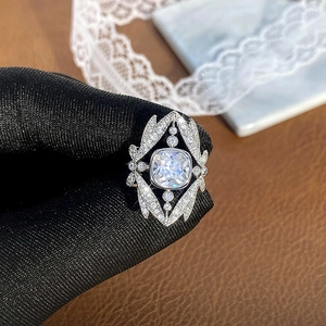 Macro detail of crown ring featuring cushion cut gemstone and hollow geometric setting