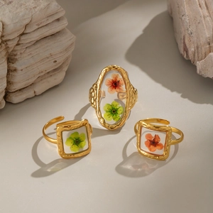 Adjustable gold hammered rings with colorful preserved flowers in resin on stone base