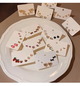 Detailed close-up of S925 silver stud earring set with cute animal and fruit designs