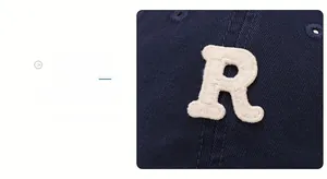 Close-up of premium blue cotton baseball cap with white 3D letter R towel embroidery