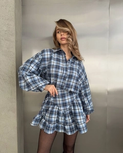 Detailed view of plaid shirt with ruffle skirt set featuring sharp blue checkered pattern