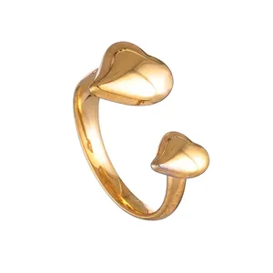 Detail of gold-plated stainless steel ring with elegant double heart design