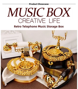 Detail of vintage rotary phone music box with gold carving and hidden jewelry drawer