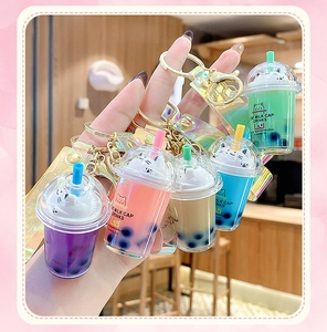 Close-up of cat bubble tea liquid keychains in purple pink beige blue and green colors