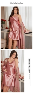 Detail of pink silk pajama set with yellow floral embroidery and silky satin texture