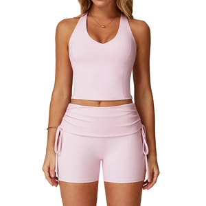 Pink racerback halter yoga top and high-waisted drawstring shorts two-piece fitness set