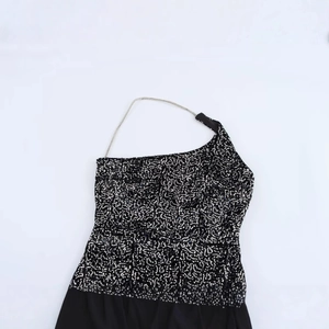 One-shoulder black sequin party dress with asymmetrical metallic chain strap detail
