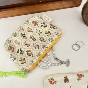 Korean style floral pattern makeup pouch with yellow zipper and green handle detail