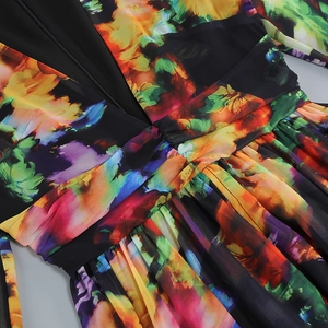 Detail of floral printed dress featuring deep V-neck and ruffled waist craftsmanship