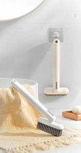 Detail of rotating multifunctional crevice brushes with wall-mounted storage hooks