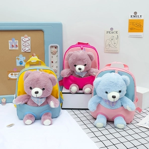 Three cute children's backpacks with plush teddy bears in pastel colors on a table