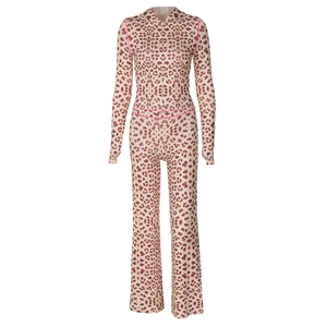 Detail of leopard print jumpsuit with pink trim and functional front zipper closure