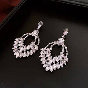 Elegant silver wheat tassel earrings with marquise rhinestones on black leather display